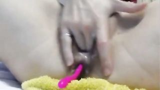 hot slut masturbating with a pink vibrat