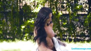 Busty brunette massage her friend outside