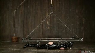 Busty MILF in heavy latex bondage