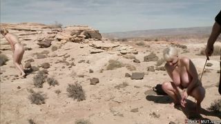 Busty blondes hogied in a desert