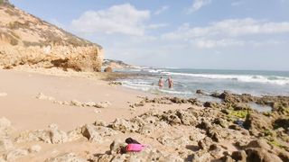 Horny girl and guy undress on a public beach and masturbate - risky