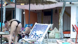 Energetic young nudist girls have fun outdoors