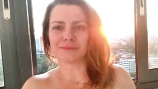 Horny MILF shakes her ass on the balcony, fucks herself with a dildo, squir
